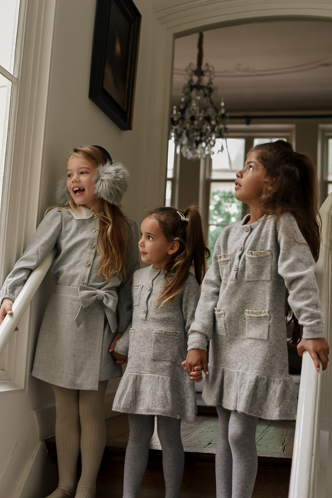 Girls wearing the Charlie Knit Dress in Dove and Elle Set in Dove on the staircase in the Canal House