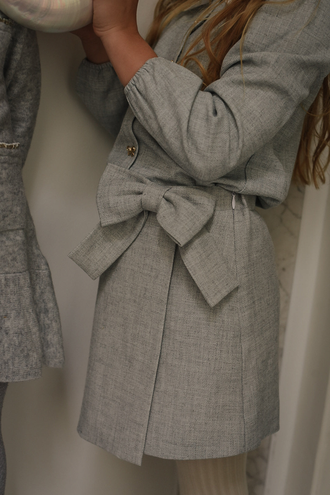 Close-up of the Elle Set in Dove showing the statement bow and woven fabric