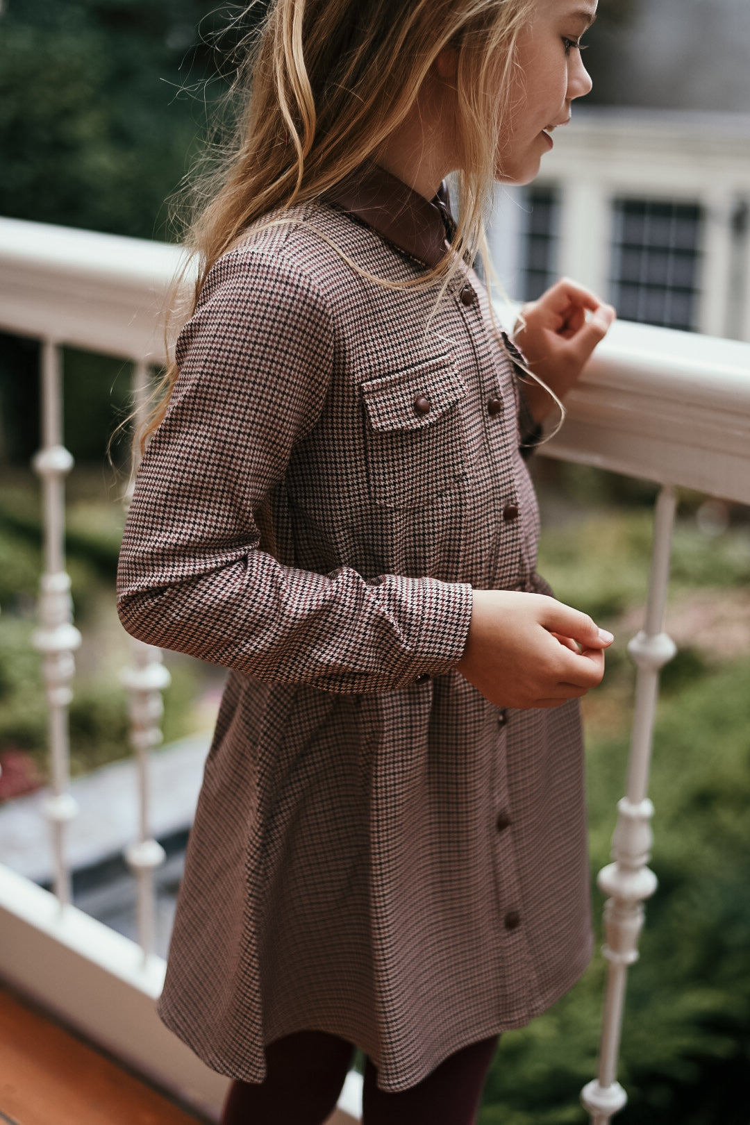 Side detail of the Isabella Dress in Houndstooth on the Canal House balcony