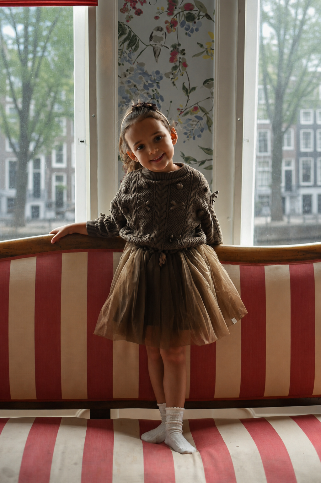 Girl wearing the Julie Tutu Skirt in Chocolate with the Elise Bow Pull inside the Canal House