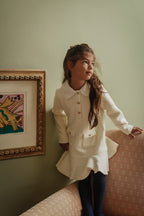 Girl wearing the Mara Tweed Dress Long Sleeve in Ivory in the Canal House
