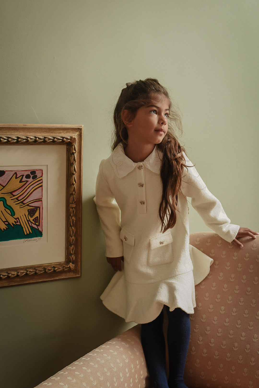 Girl wearing the Mara Tweed Dress Long Sleeve in Ivory in the Canal House