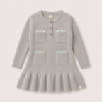 Charlie Knit Dress in Dove with silver-tone flower buttons and patch pockets on a neutral background