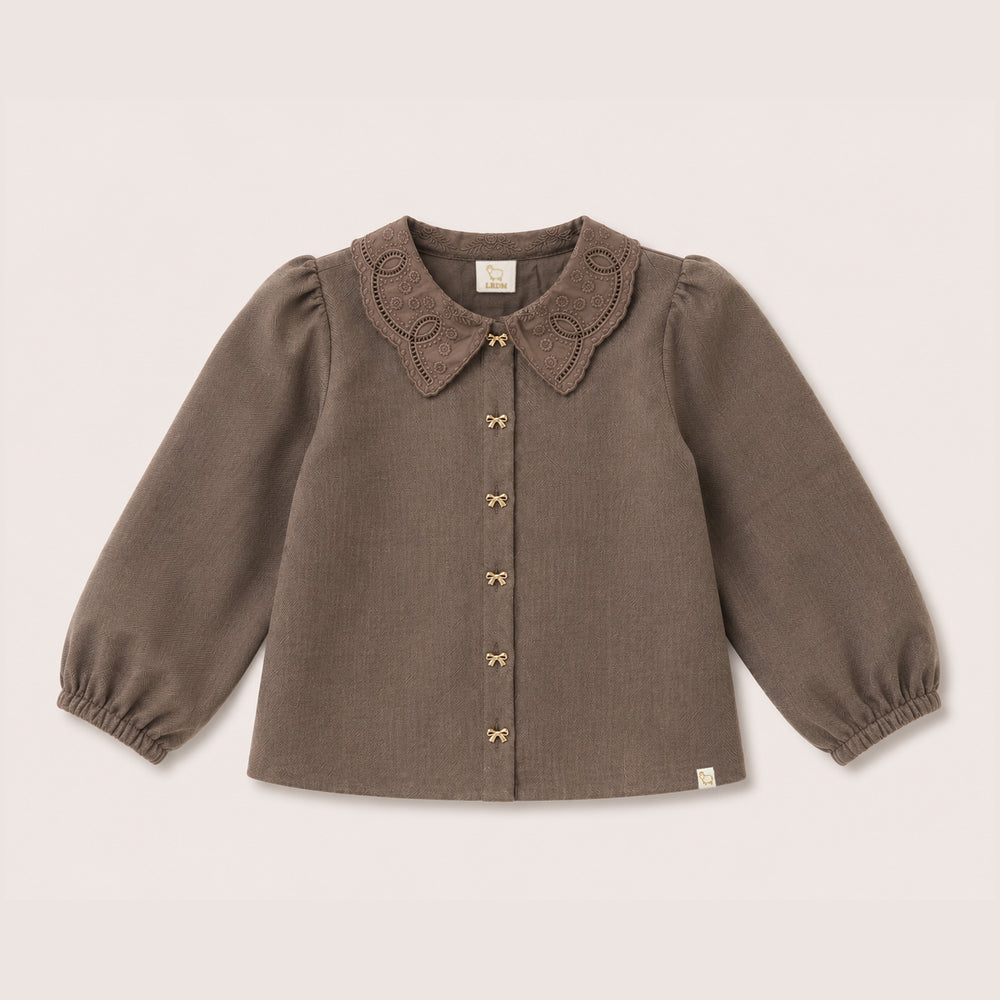 Elle Blouse in Chocolate on a neutral background