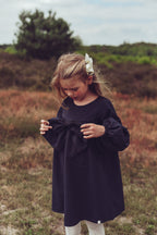 Girl wearing the Elle Dress in Navy on the heath