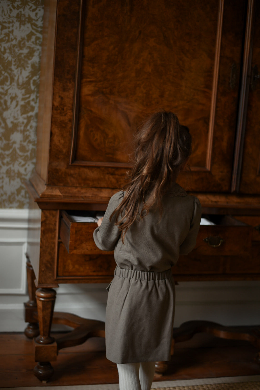 Back view of the Elle Blouse and matching skirt in Chocolate