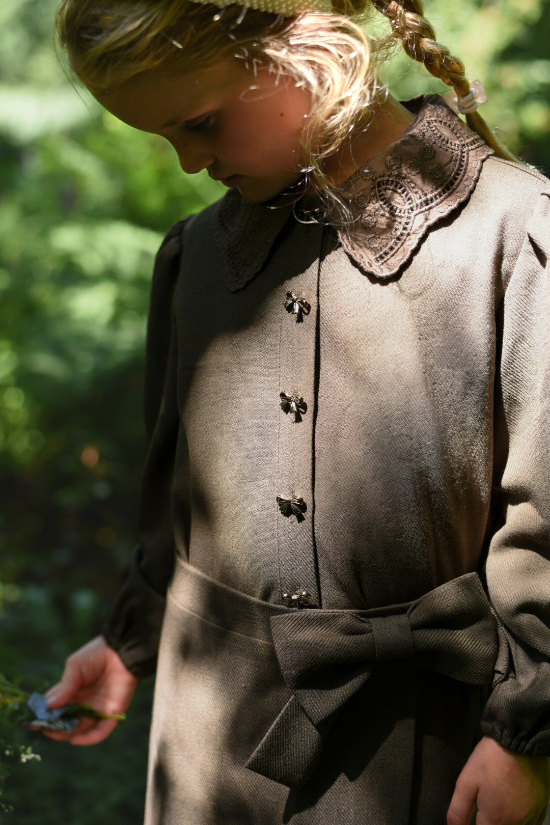 Detail of the Elle Skirt in chocolate styled with the matching blouse in the woodland