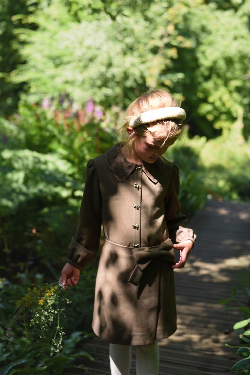 Girl wearing the chocolate Elle Blouse with the matching skirt in the woodland