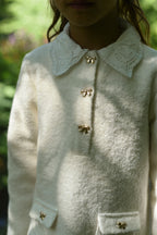 Close-up of the long-sleeve Mara Tweed Dress details in the woodland