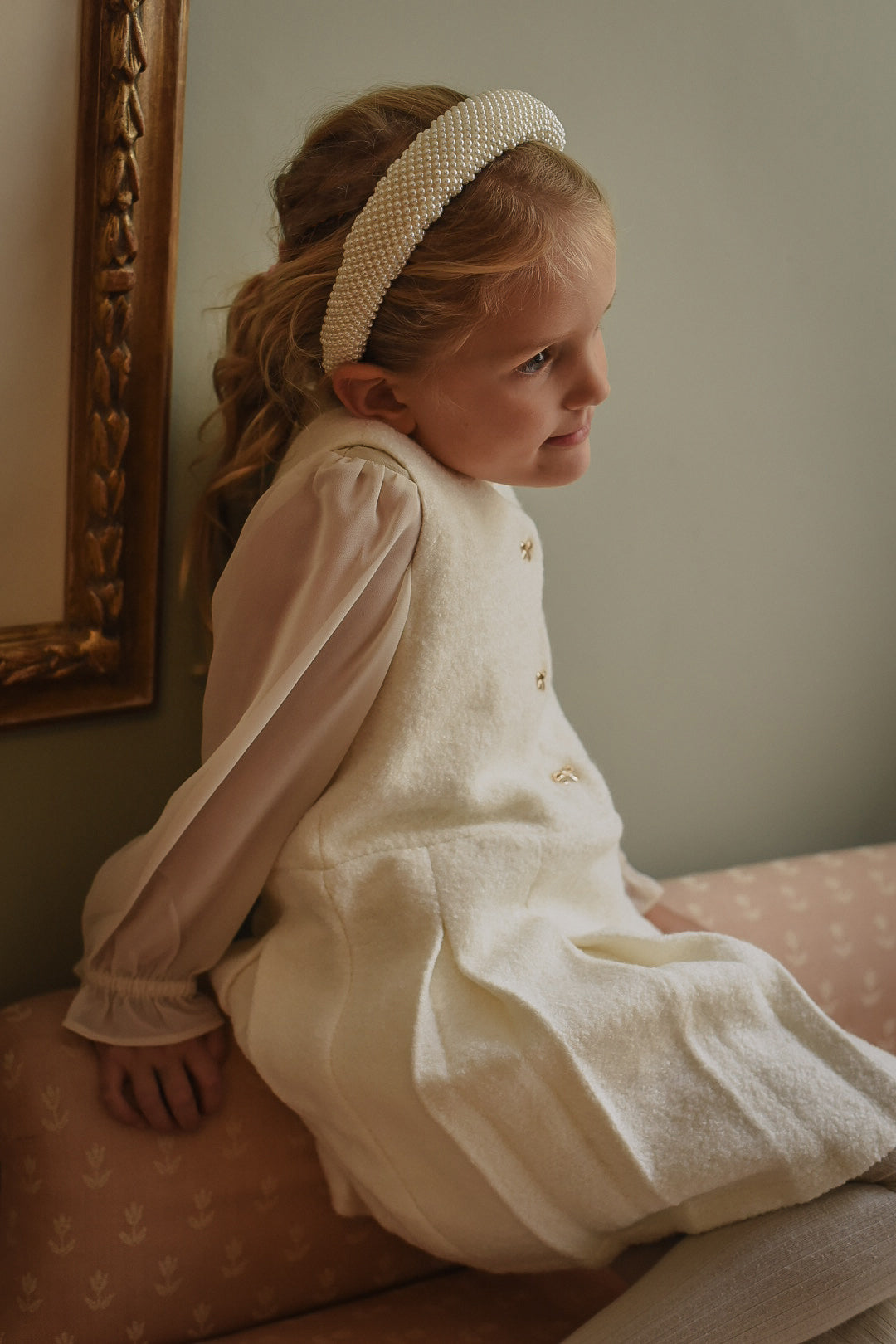 Side view of the Mara Tweed Dress in Ivory layered over the Zara Blouse in Sand