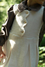 Two girls wearing ivory Mara Tweed and chocolate Elle looks in the woodland