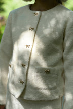 Close-up of the Mara Tweed Jacket details in the woodland