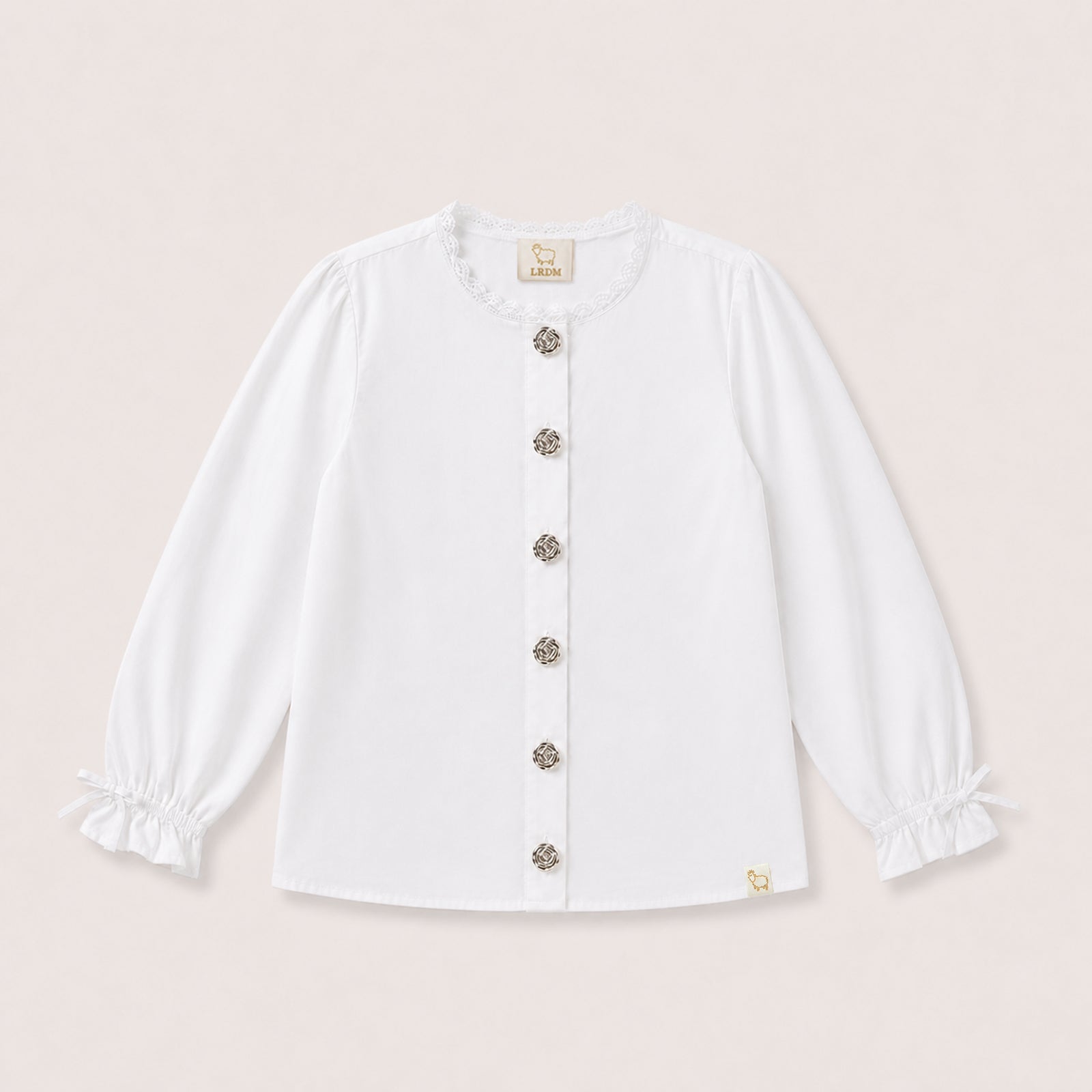 Valery Blouse in White with ruffle collar and gold buttons on a neutral background