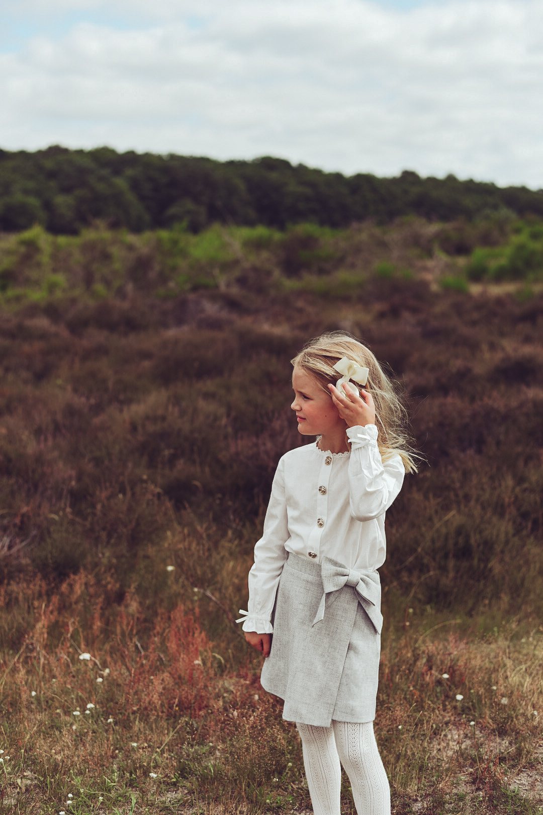 Girl wearing the Elle Skirt in dove with the Valery Blouse on the heath