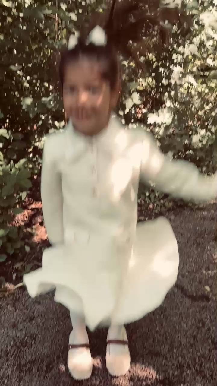 Girl moving through the heath in the LRDM Petits AW26 collection