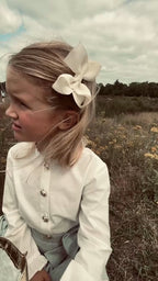 Girl wearing the Valery Blouse in Ivory on the heath