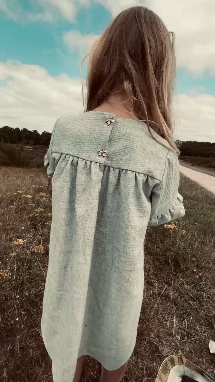 Girl wearing the Elle Dress in Dove on the heath