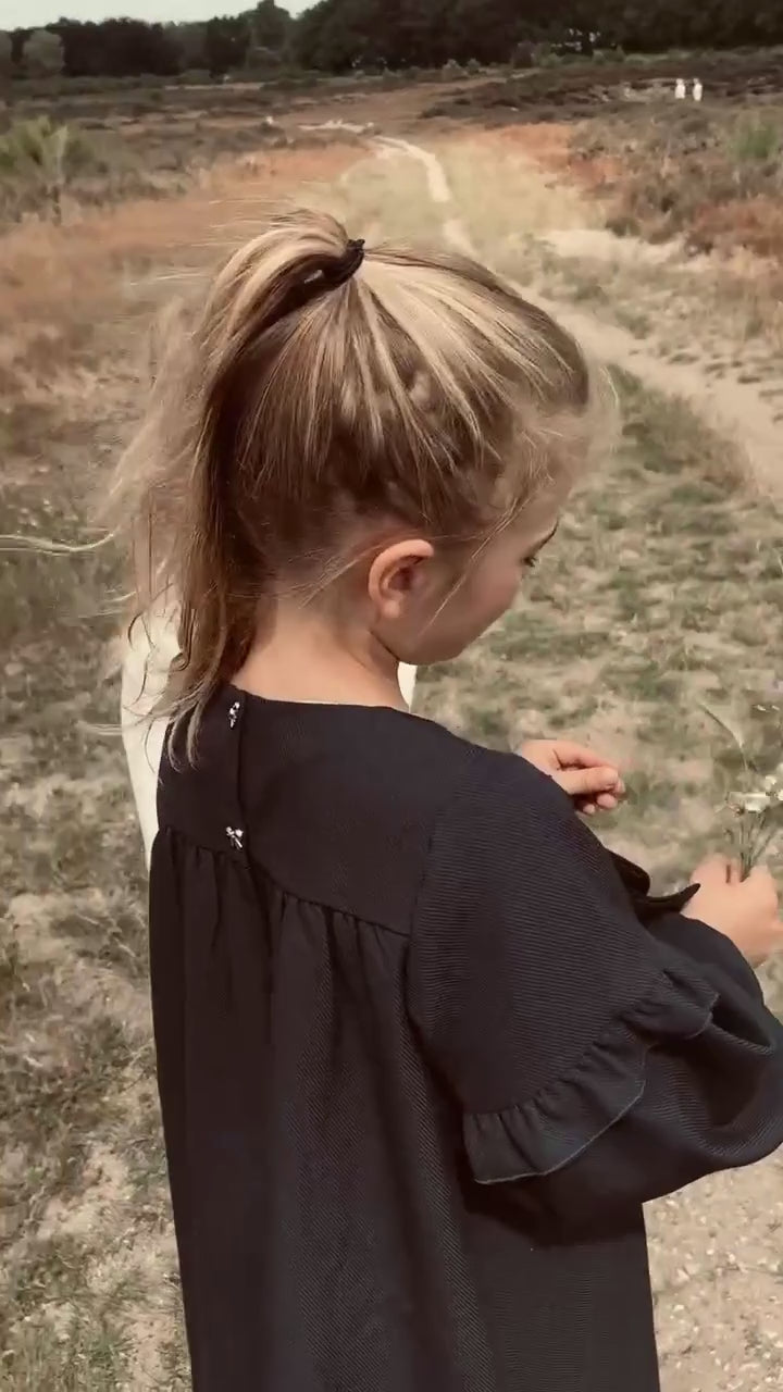 Girl wearing the Elle Dress in Navy on the heath